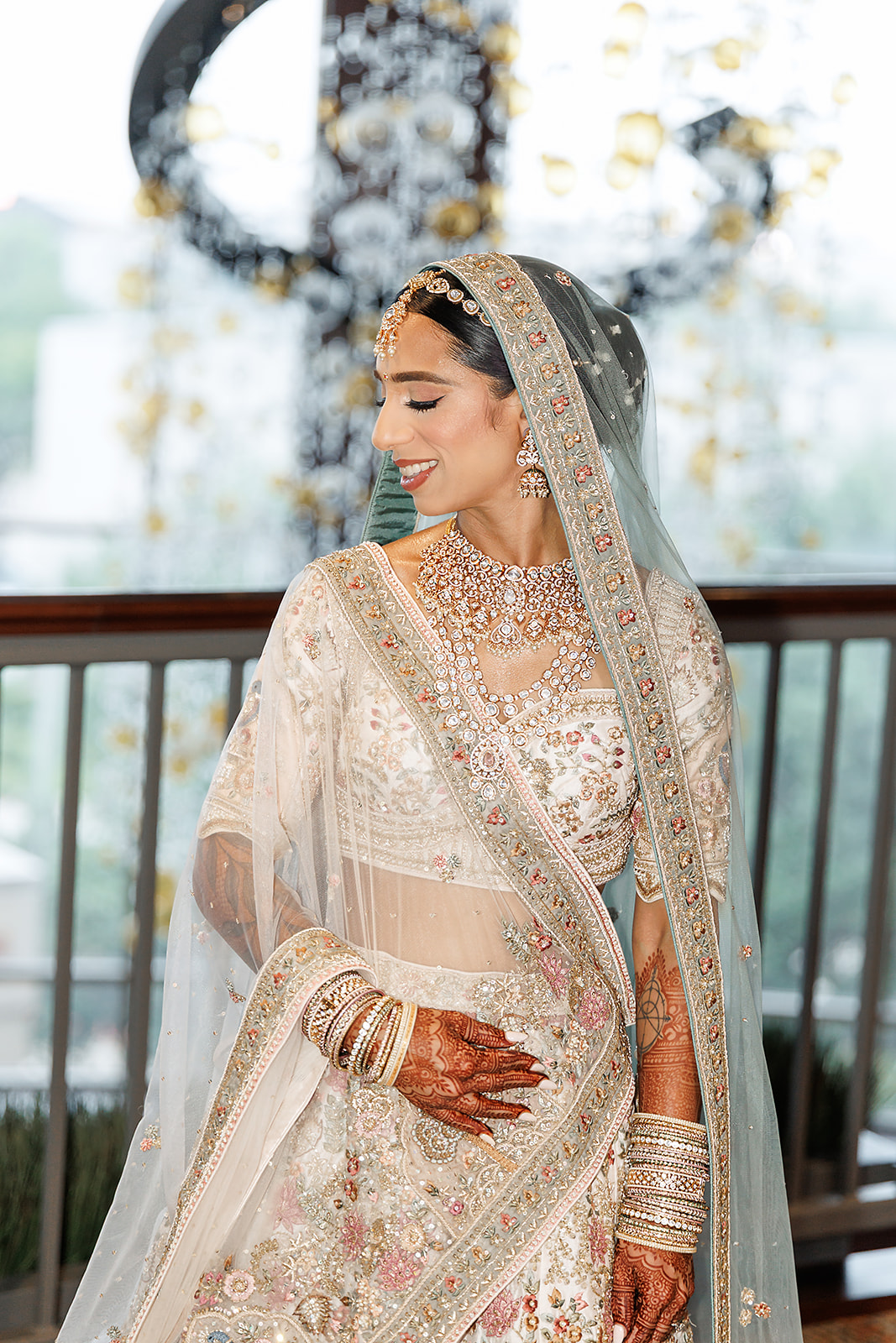 South Asian bridal beauty with an ivory lehenga and pale blue dupatta