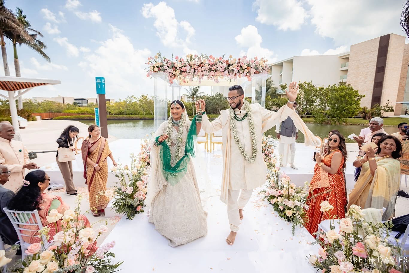 Bride and groom walking down the aisle at an outdoor destination wedding ceremony.