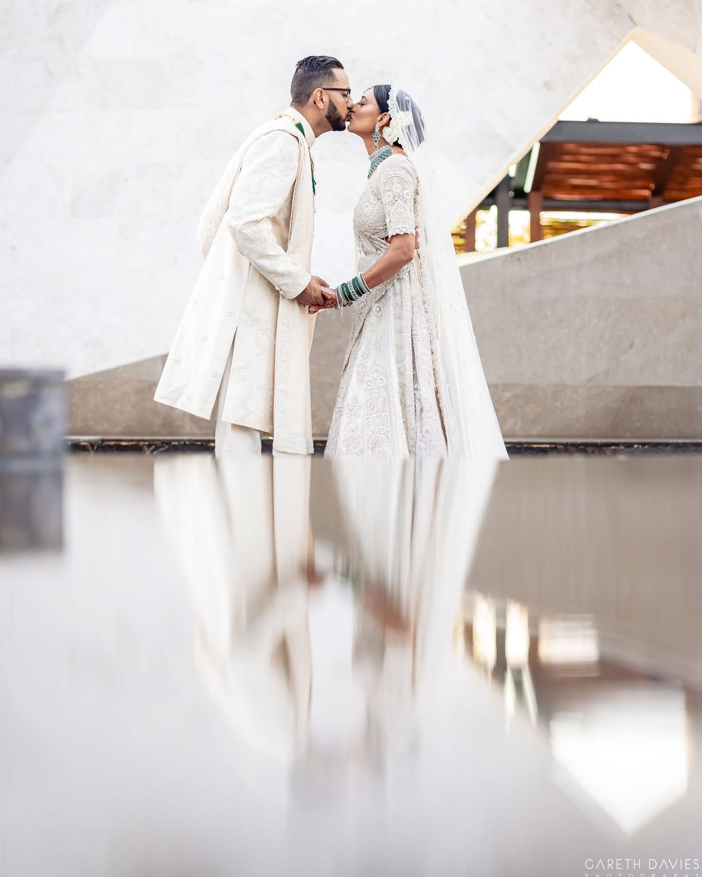 Bride and groom sharing a kiss at a destination wedding.