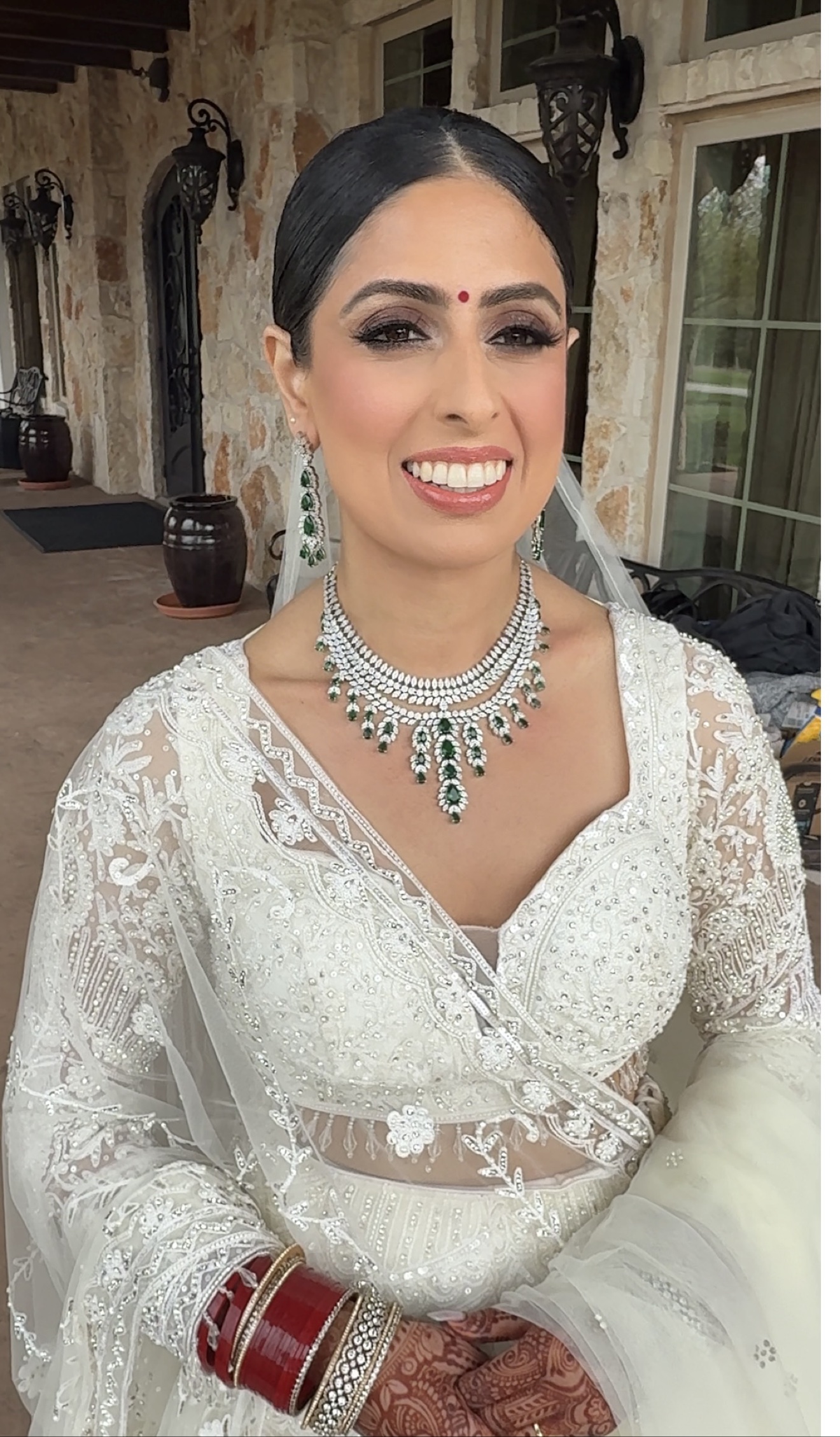 JTorry bride Rekha Thapa Basnet wearing an ivory embroidered bridal look with emerald and diamond jewelry