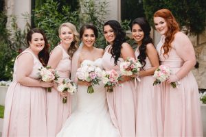 Western bride in white gown with bridesmaids in blush pink dresses